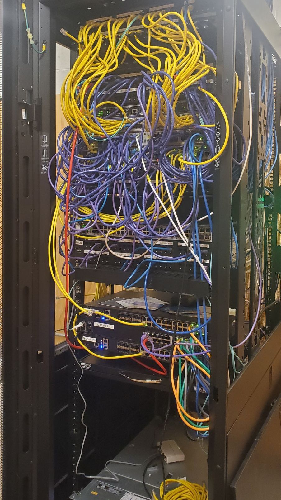A server rack filled with lots of wires and cables.