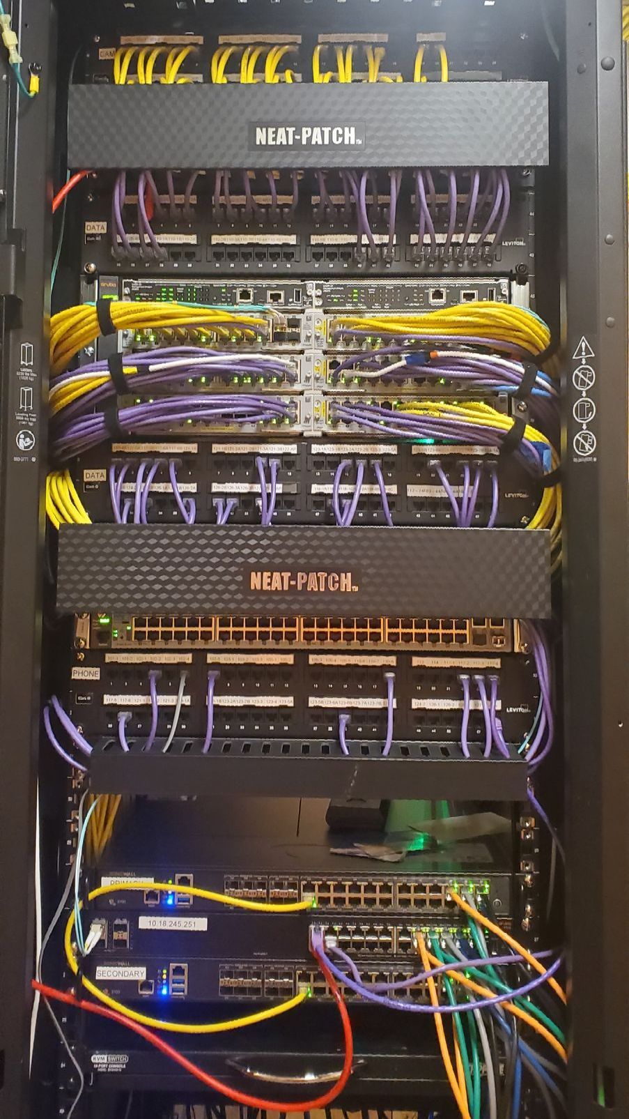 A server rack filled with lots of wires and cables.