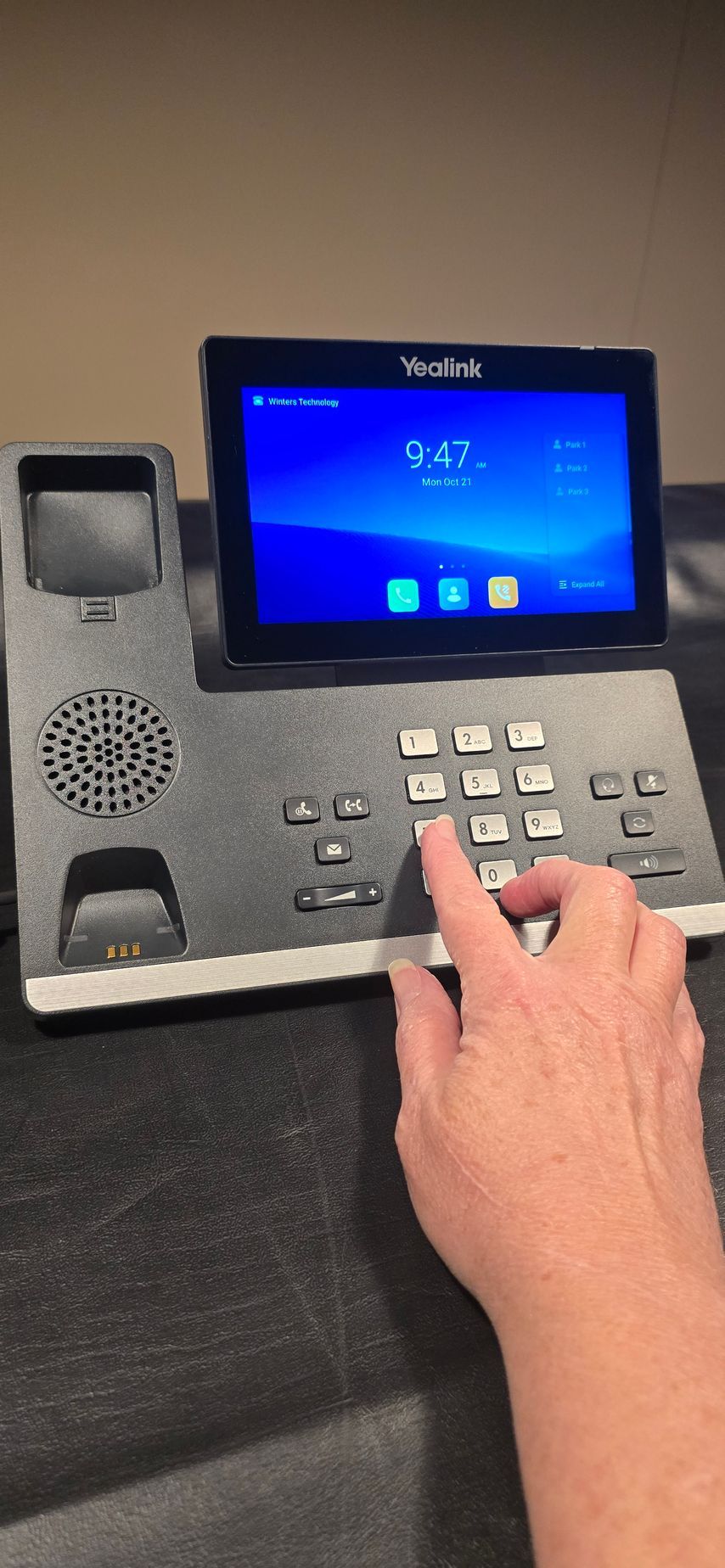 A person is pressing a button on a telephone.