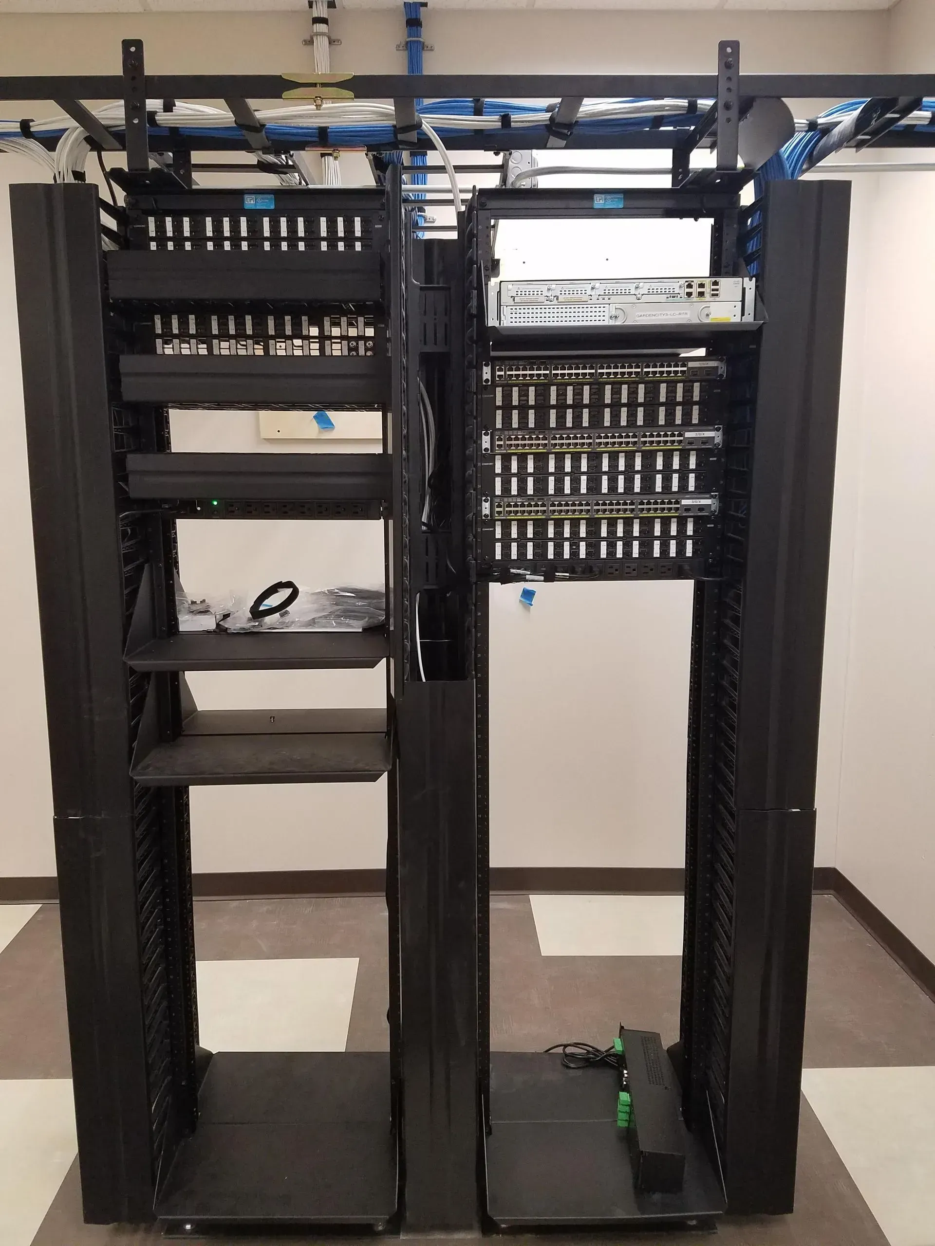 A server rack with a lot of wires hanging from it
