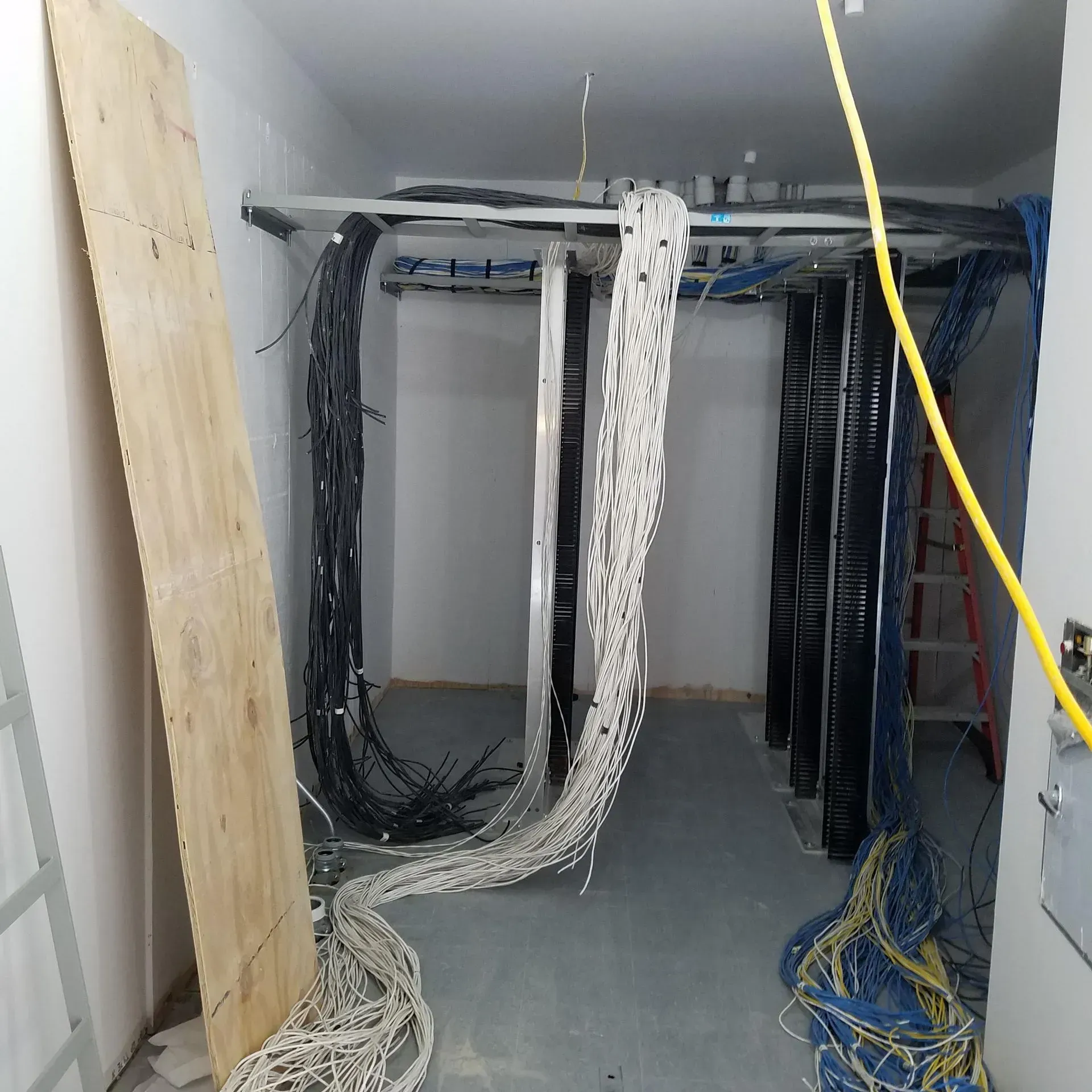 A room with a lot of wires hanging from the ceiling