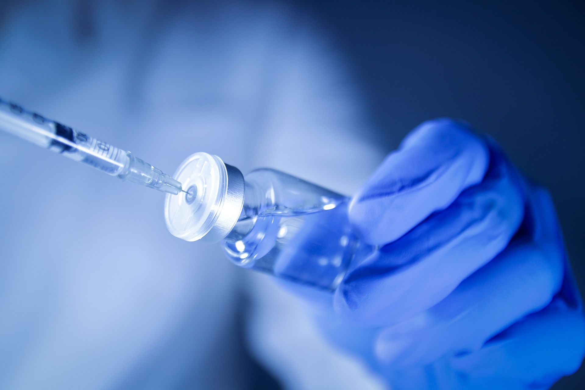 Doctor Holding a Syringe and Vial