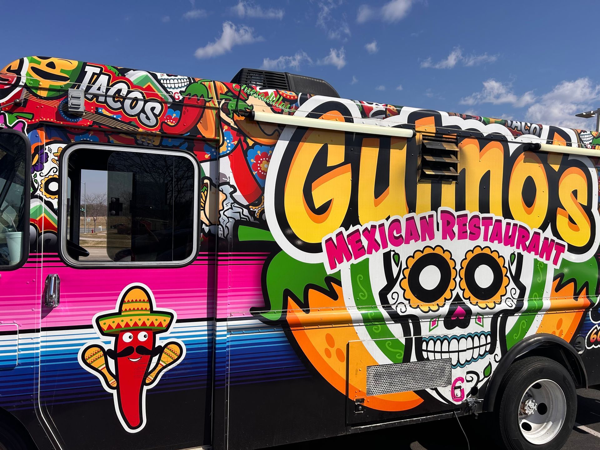 A colorful food truck that says cuenos mexican restaurant