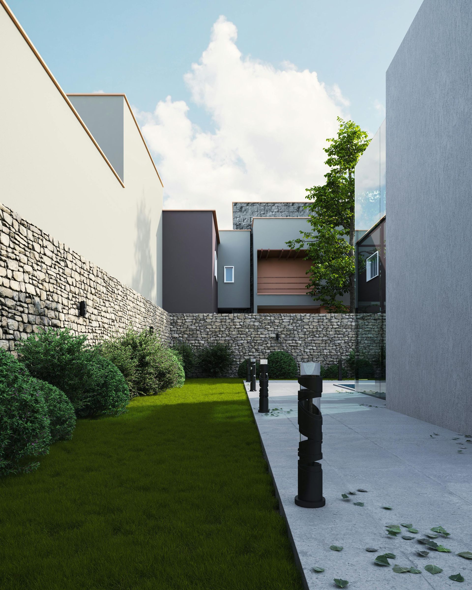 Modern courtyard with grass, stone wall, and minimalist house walkway under a blue sky
