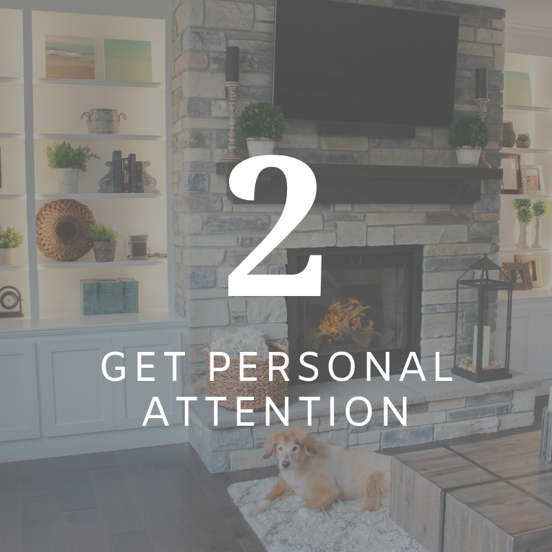 Living room with fireplace, TV, and a dog; text reads “2 GET PERSONAL ATTENTION”