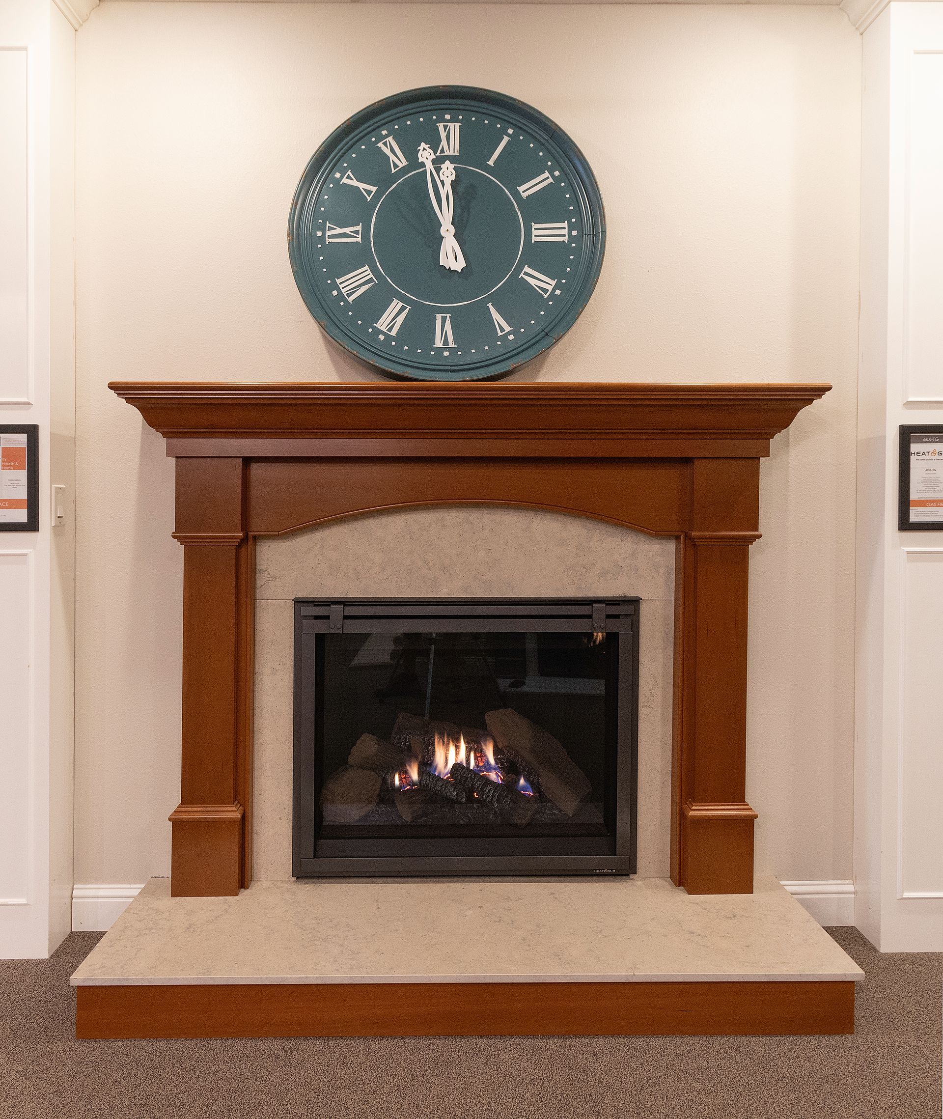 Brick fireplace with a lit fire and a large blue wall clock above the mantel.
