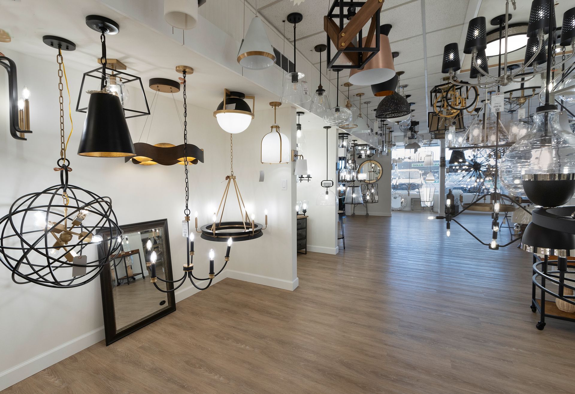 Interior of a lighting showroom with assorted hanging lamps and fixtures on display