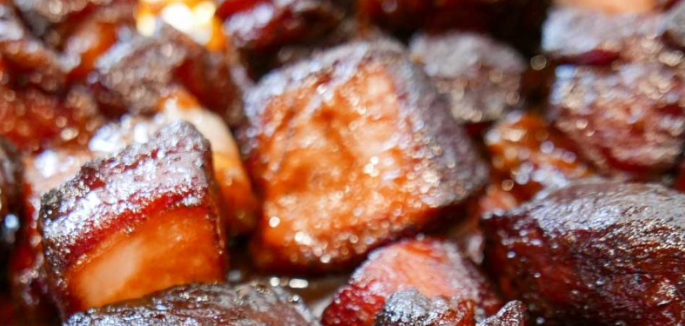 Close-up of caramelized glazed meat cubes with a glossy brown-red coating