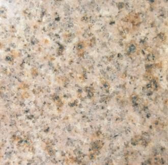 Close-up of a beige speckled granite countertop surface