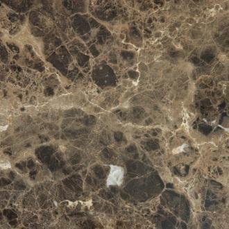 Aerial view of rocky brown desert terrain with scattered pale paths and a small white structure near center