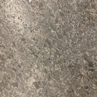 Close-up of a rough gray stone surface with speckled texture