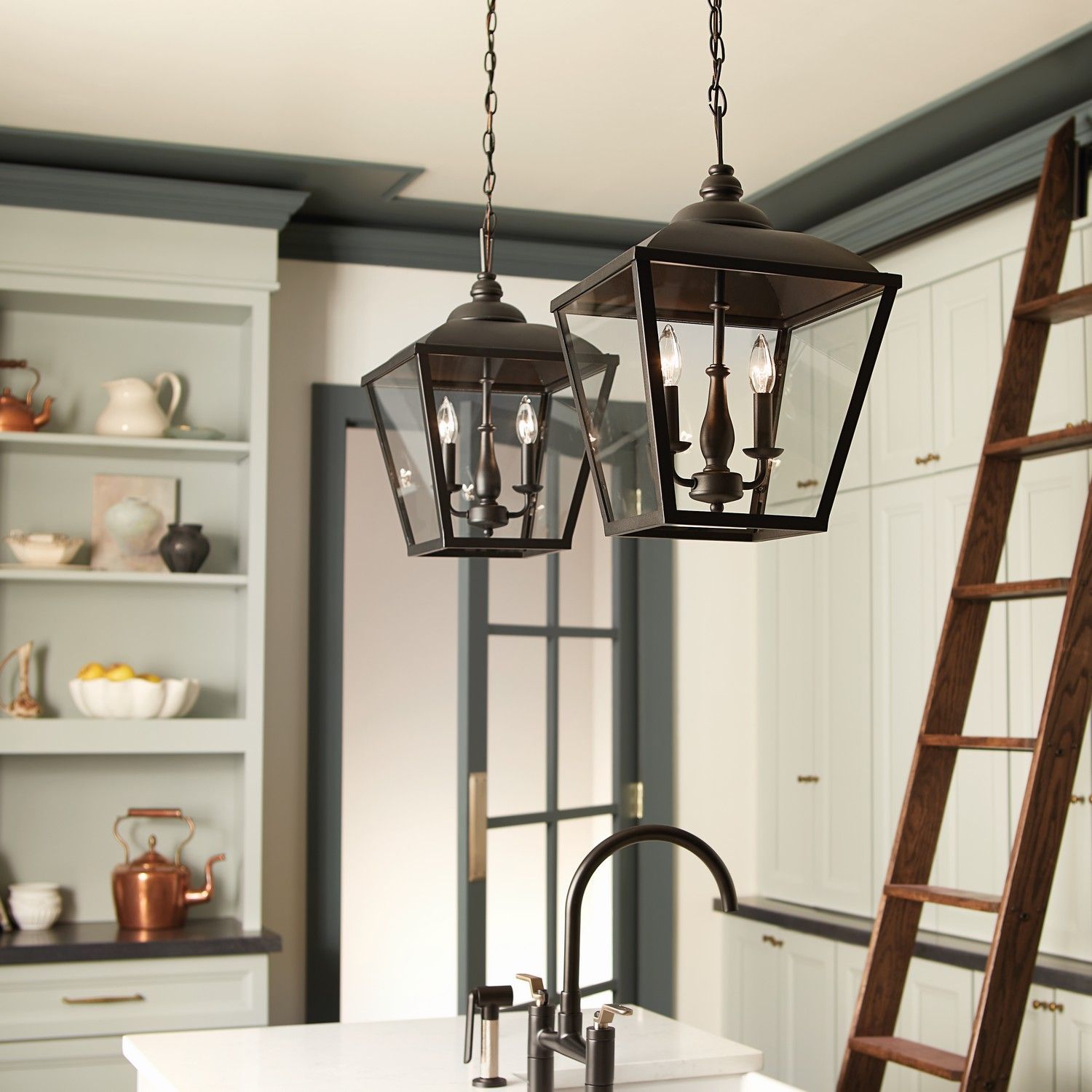 Modern kitchen with hanging lantern lights, open shelving, and a wooden ladder by white cabinets.