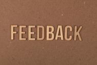 Raised beige letters spelling “FEEDBACK” on a brown textured background