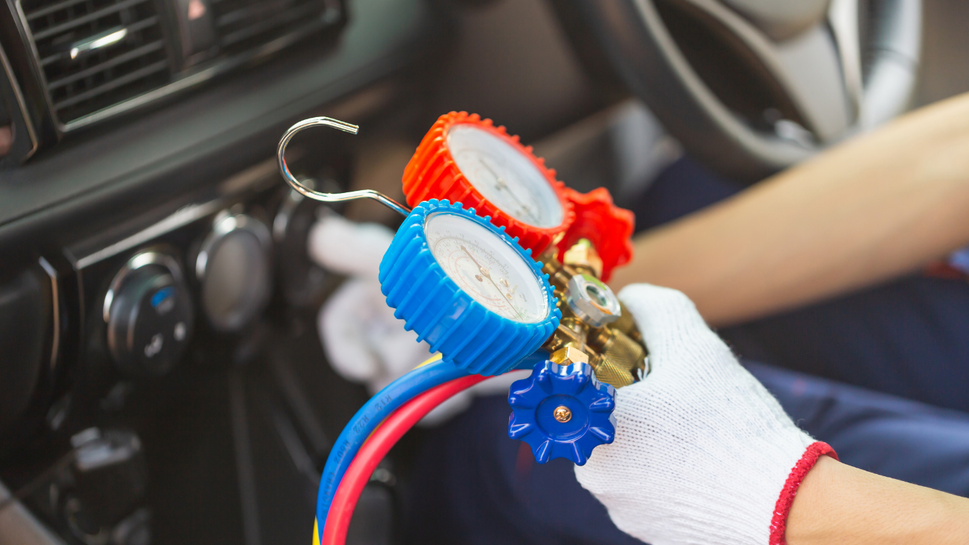 A person is holding a gauge in their hand in a car.