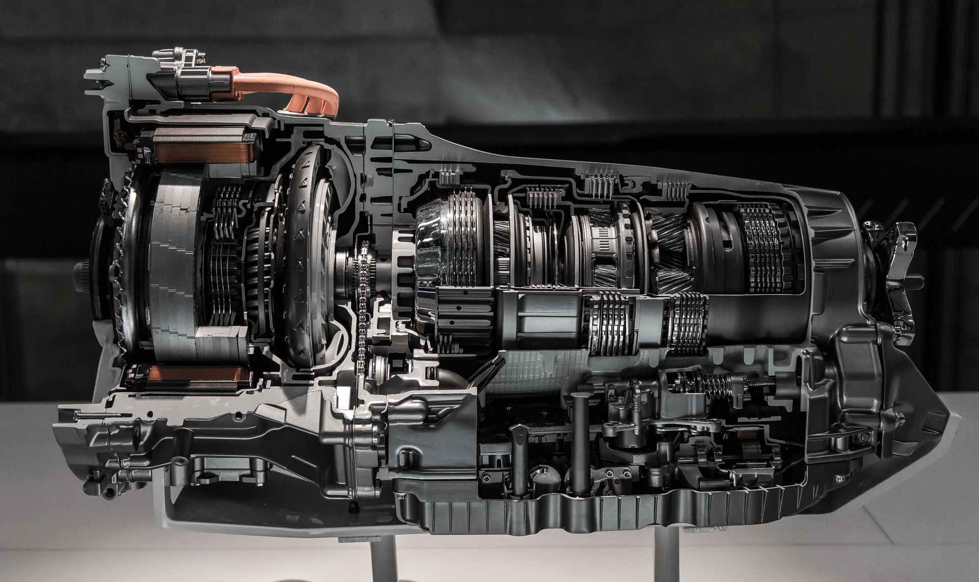 Cutaway view of a modern jet engine with visible internal components, in dark metallic tones
