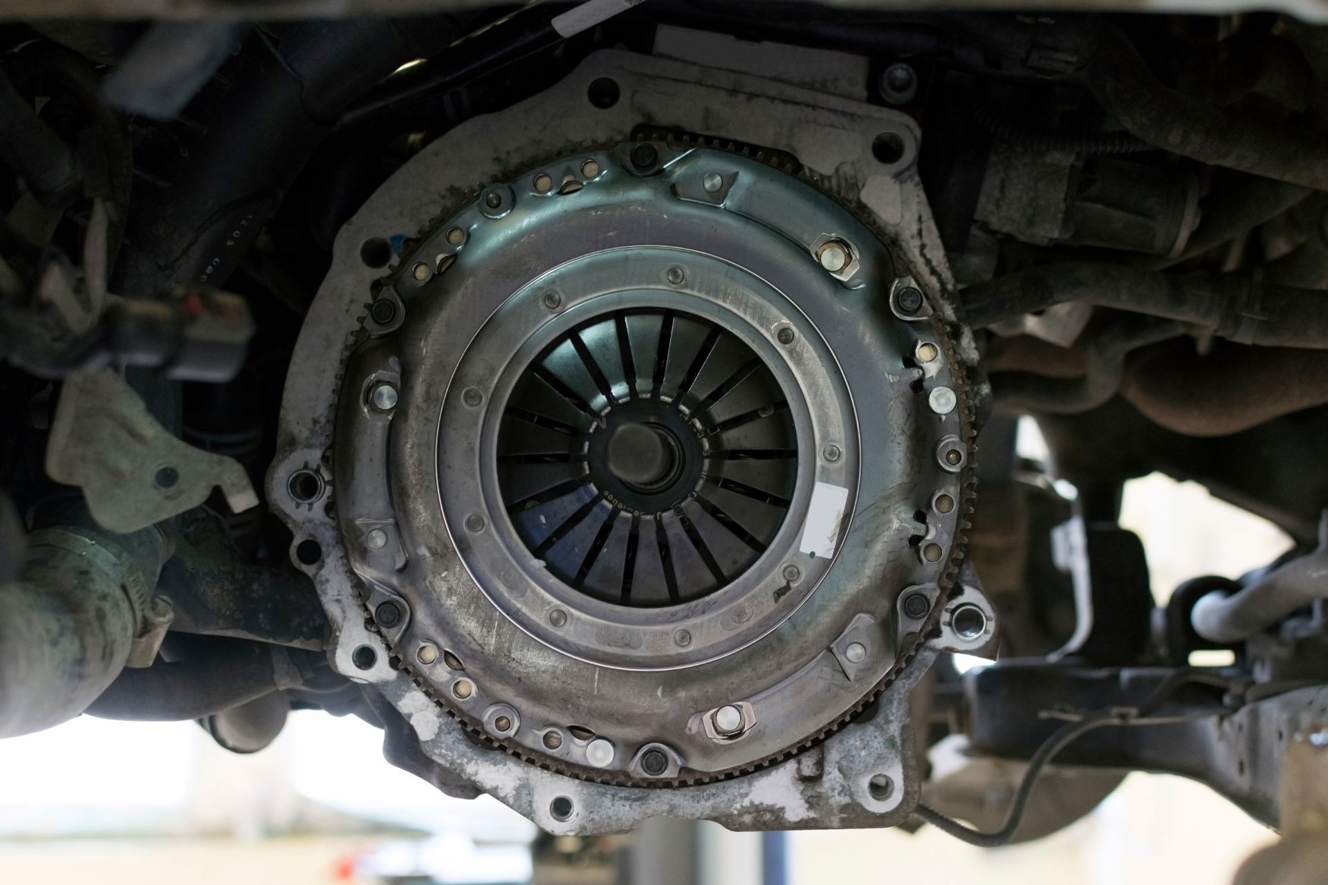 Close-up of a car’s exposed clutch assembly and pressure plate inside the transmission area.