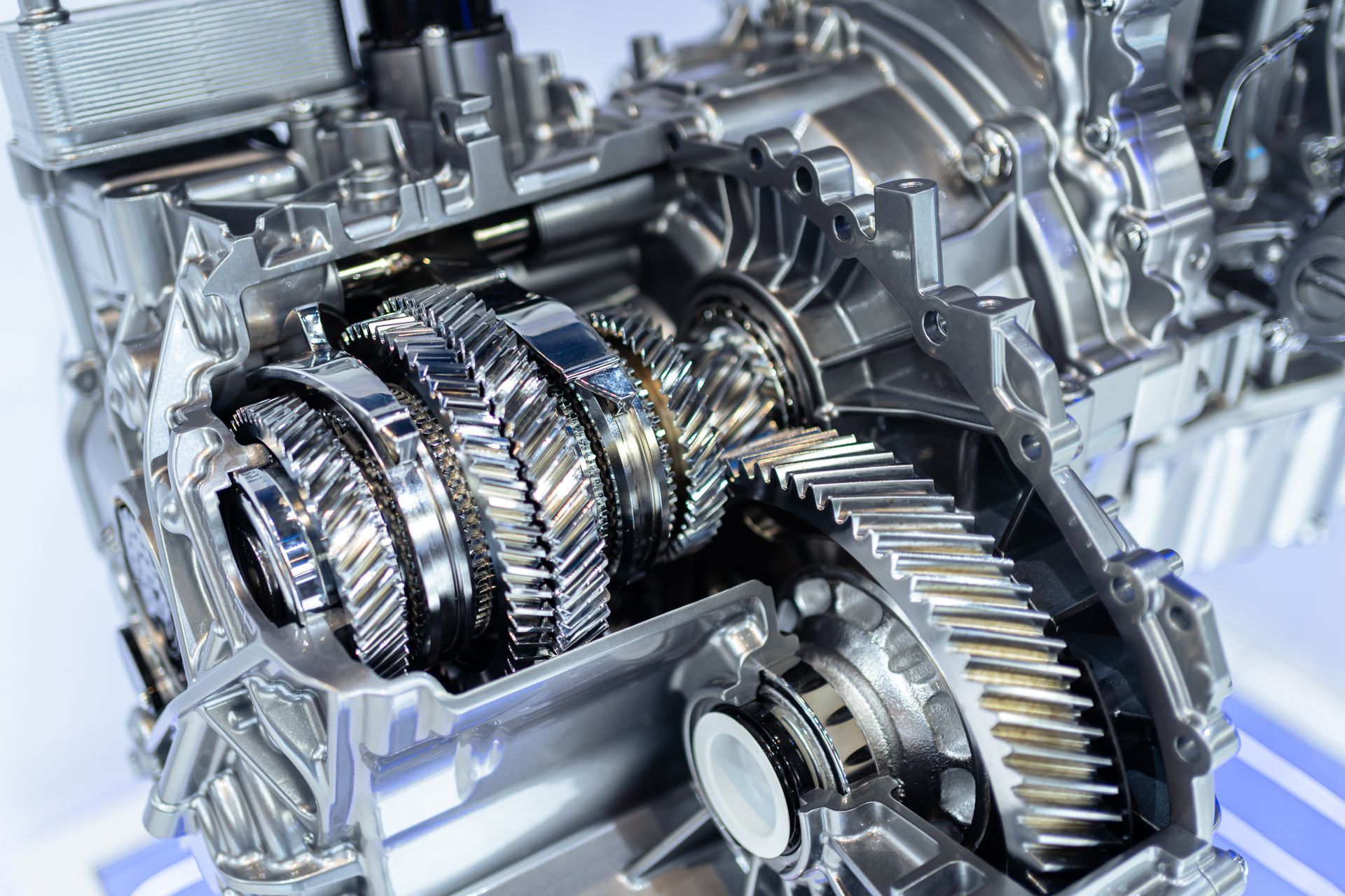 Close-up of a shiny metal transmission gearbox with interlocking gears and shafts