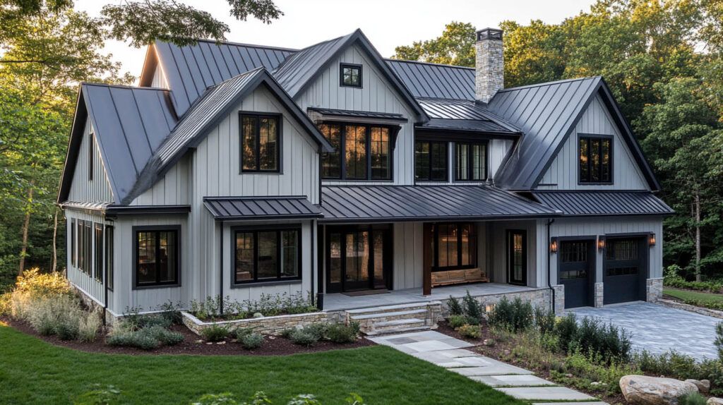 Large gray modern farmhouse with dormer windows, stone walkway, and landscaped front yard at dusk