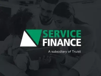 Service Finance logo over a dark background with two blurred people in the background, “A subsidiary of Truist” text