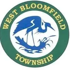 West Bloomfield Township seal with a blue heron, fish, and green circular border