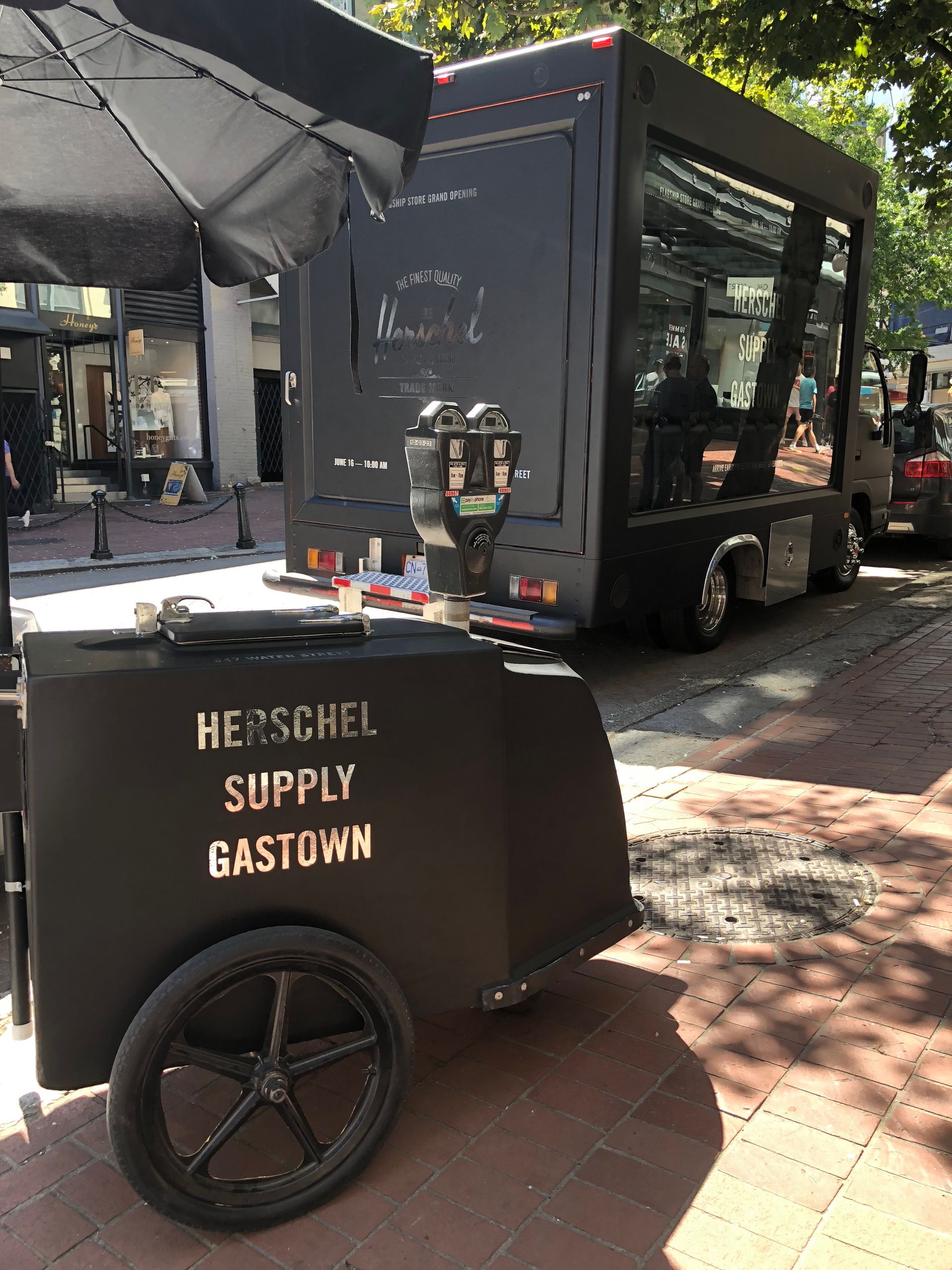 A herschel supply gastown food truck is parked on the side of the road