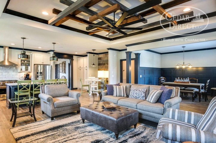 A living room with a couch , chairs , and a coffee table.