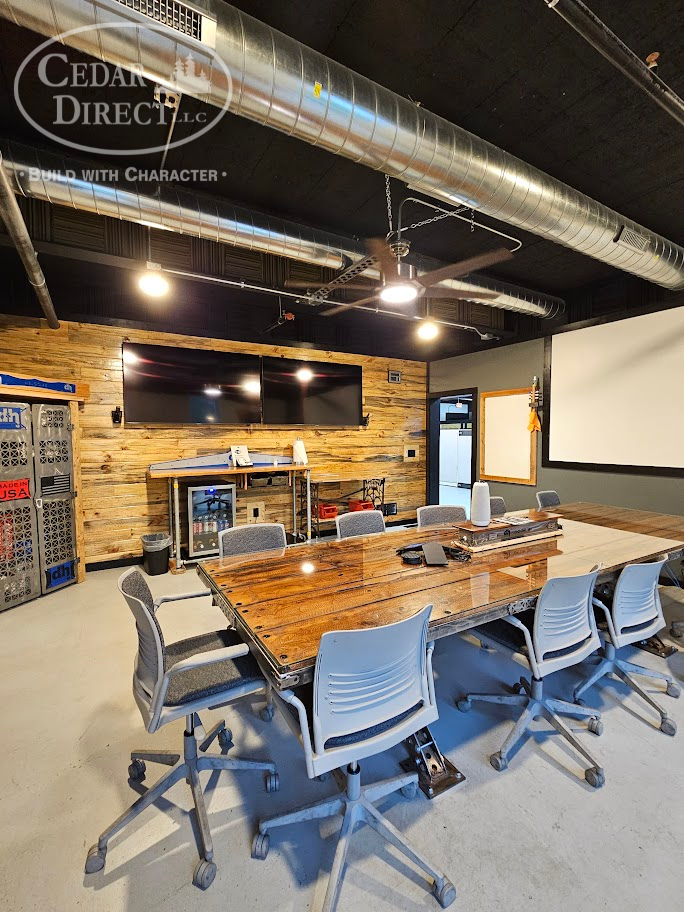 A conference room with a large wooden table and chairs