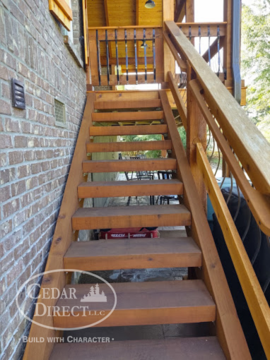 A set of wooden stairs leading up to a deck built by cedar direct