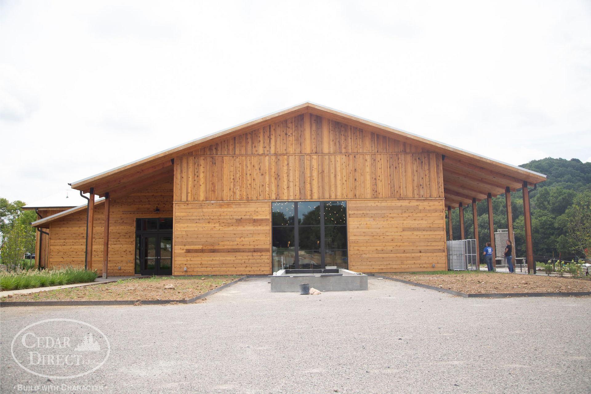A large wooden building with a roof and a lot of windows.
