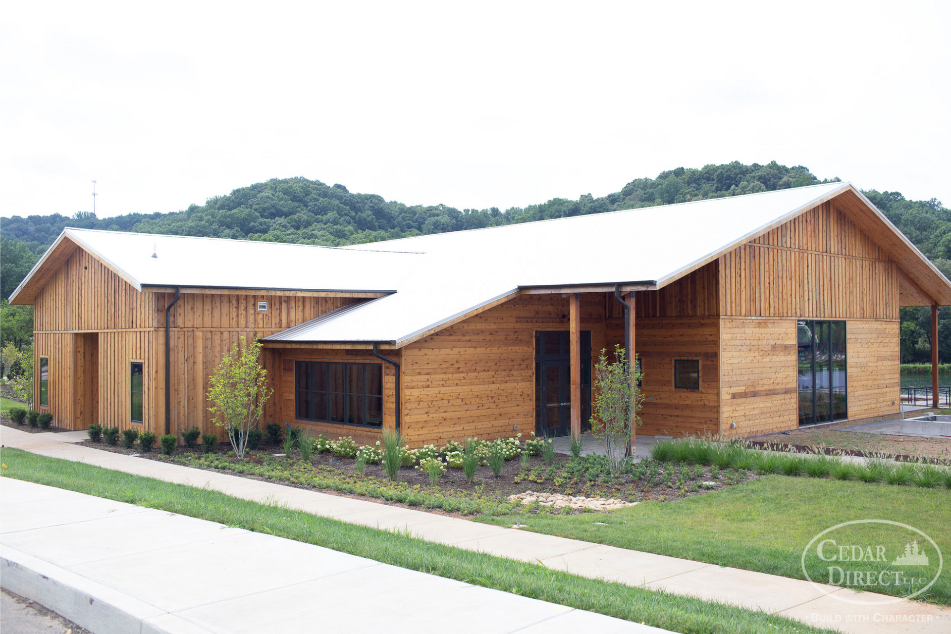 A large wooden building with a white roof