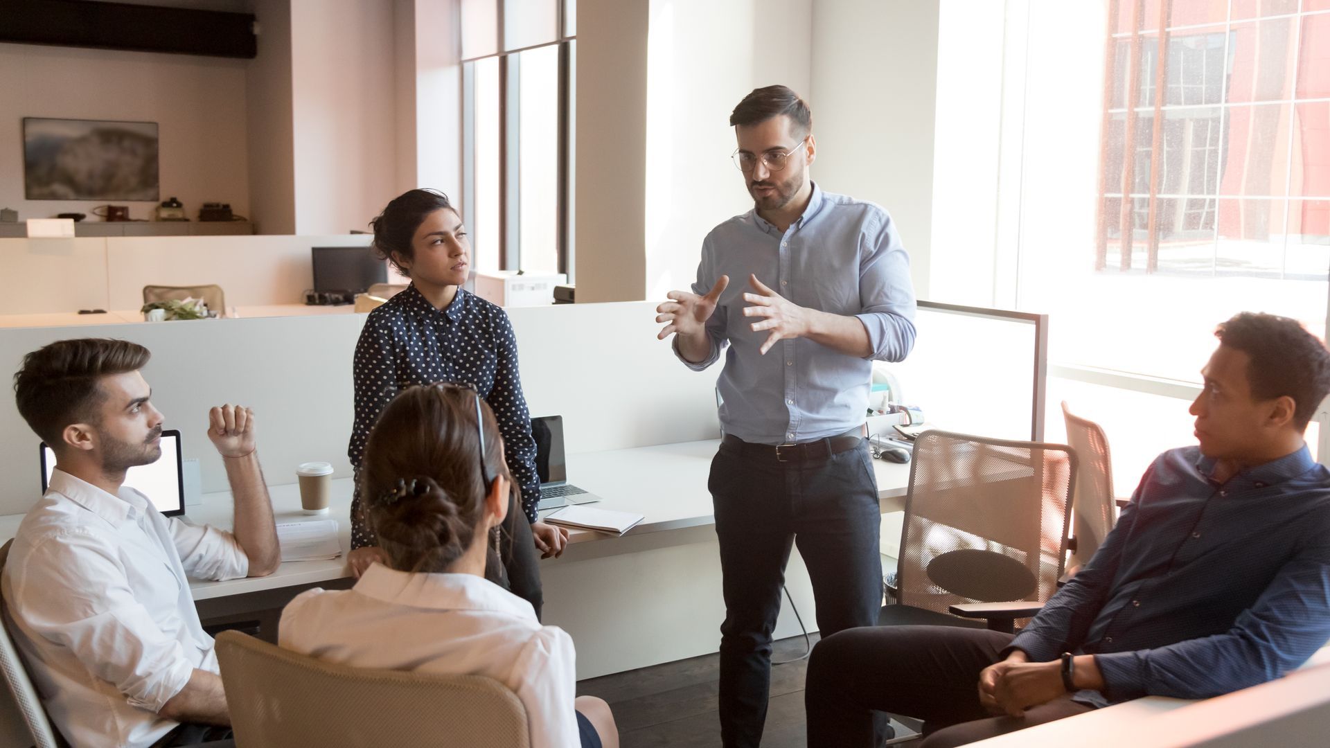 A group of people are having a meeting in an office.
