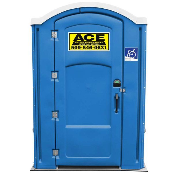 Blue portable restroom with handicap-accessible sign and ACE label on the door
