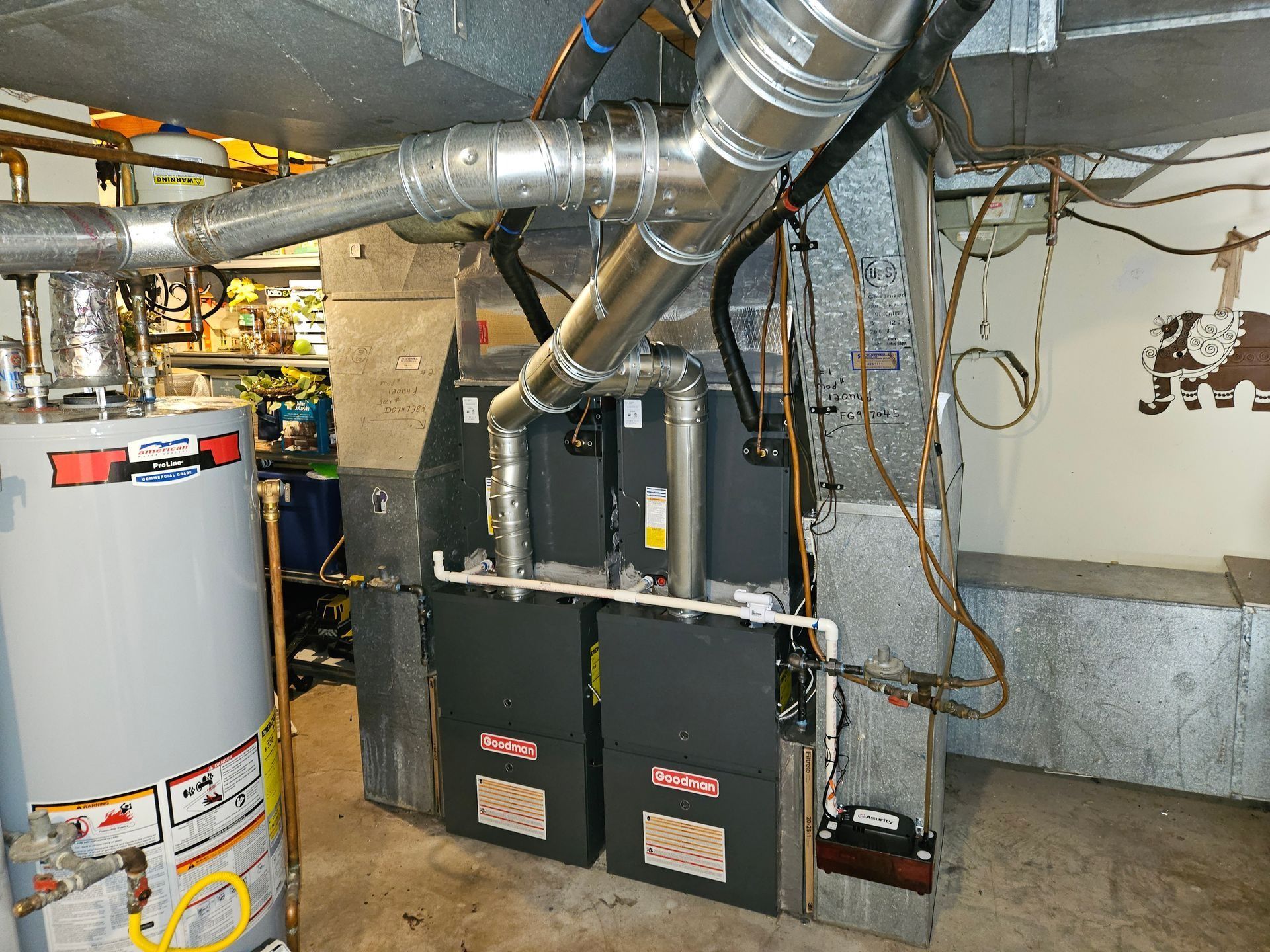 Basement furnace and water heater with exposed ductwork and wiring
