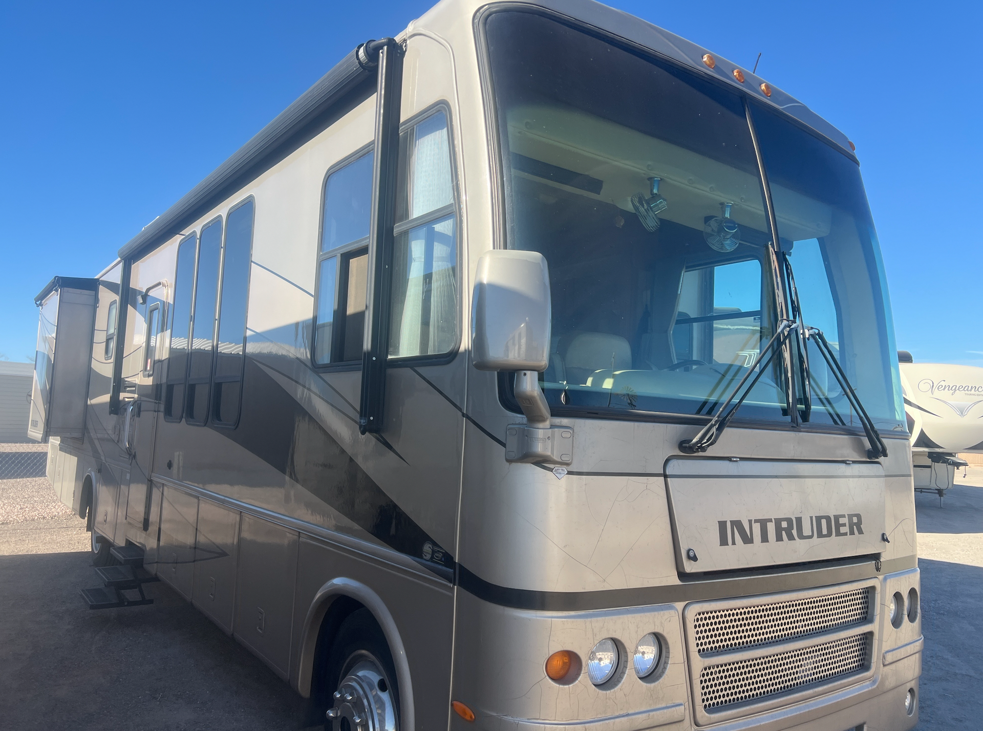 A large rv is parked in a parking lot.