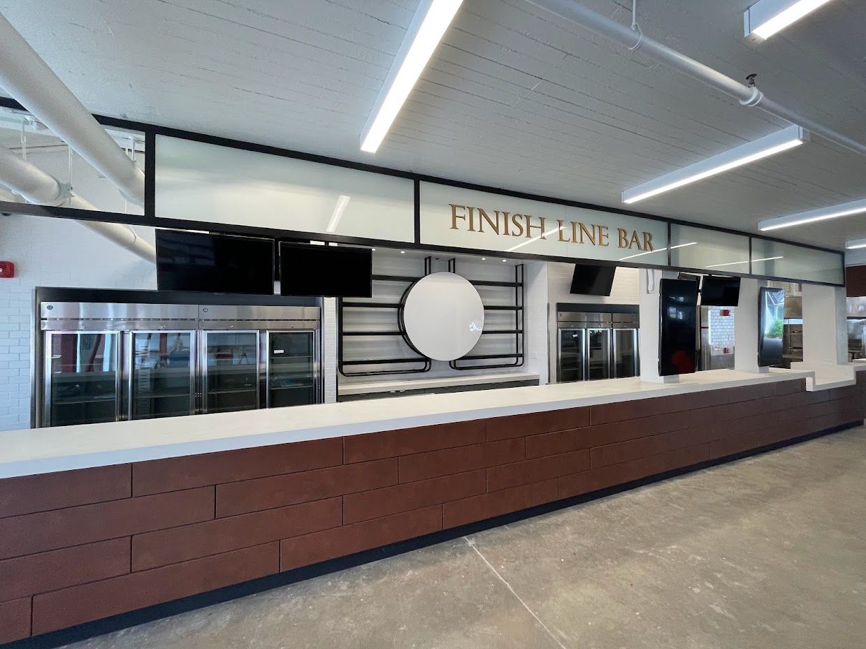 Modern indoor bar counter with a white top, brown brick base, and 