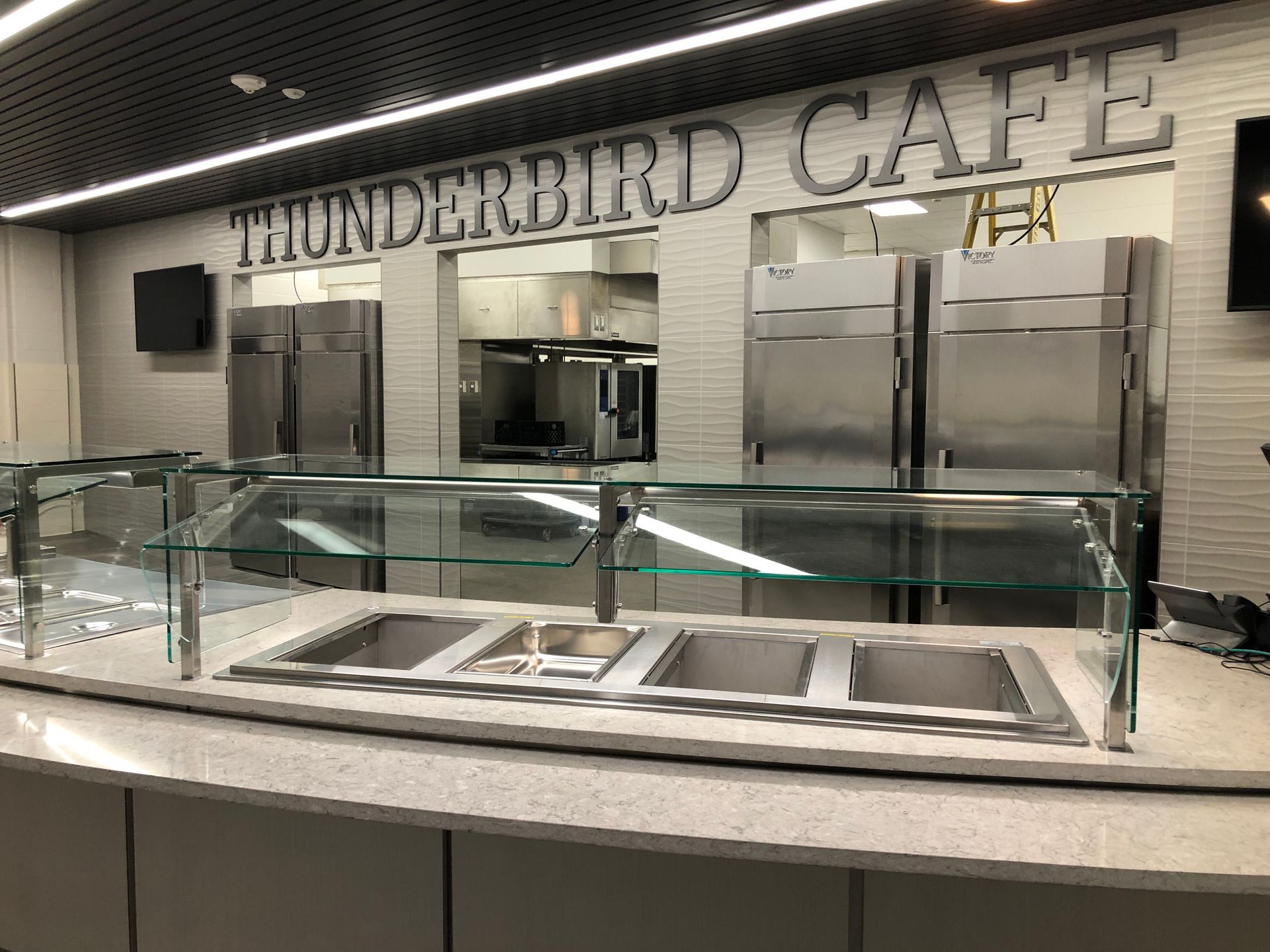 A modern cafeteria serving area with the name 