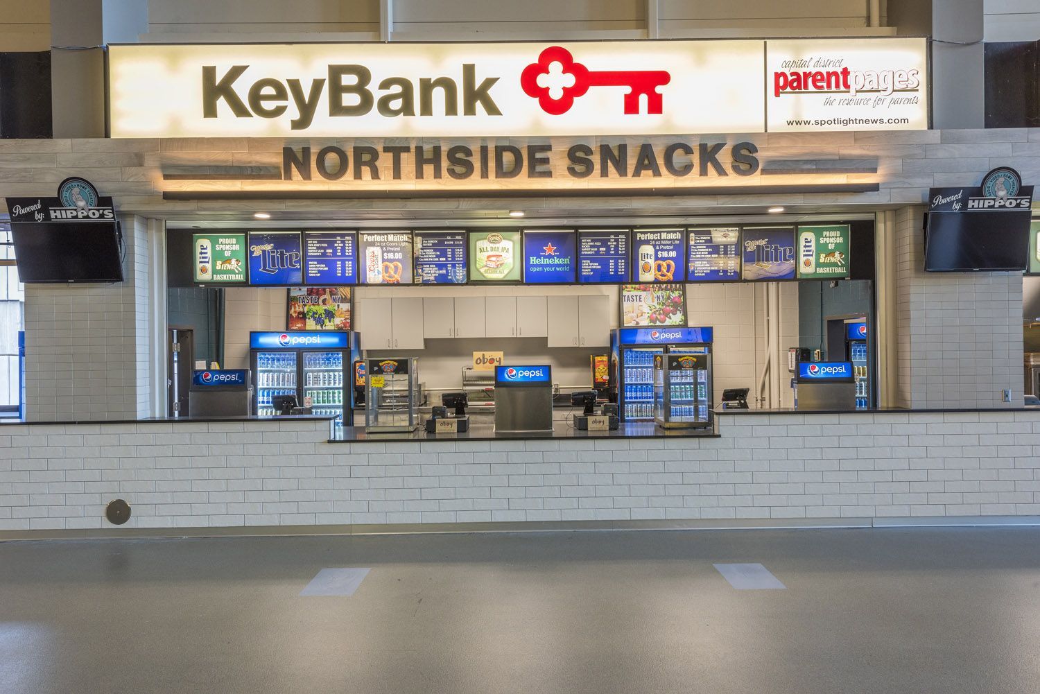 A concession stand named Northside Snacks inside a building, featuring a KeyBank sign above the service counter.