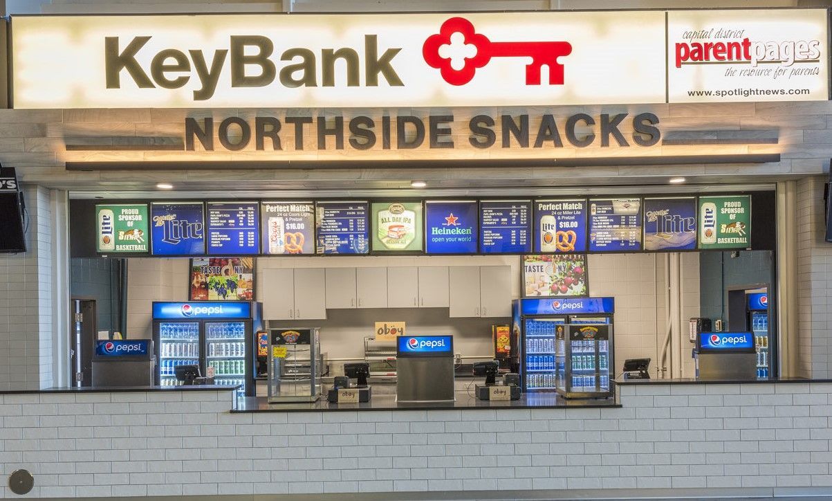 A concession stand named Northside Snacks, branded with KeyBank signage and illuminated menu boards above the counter.