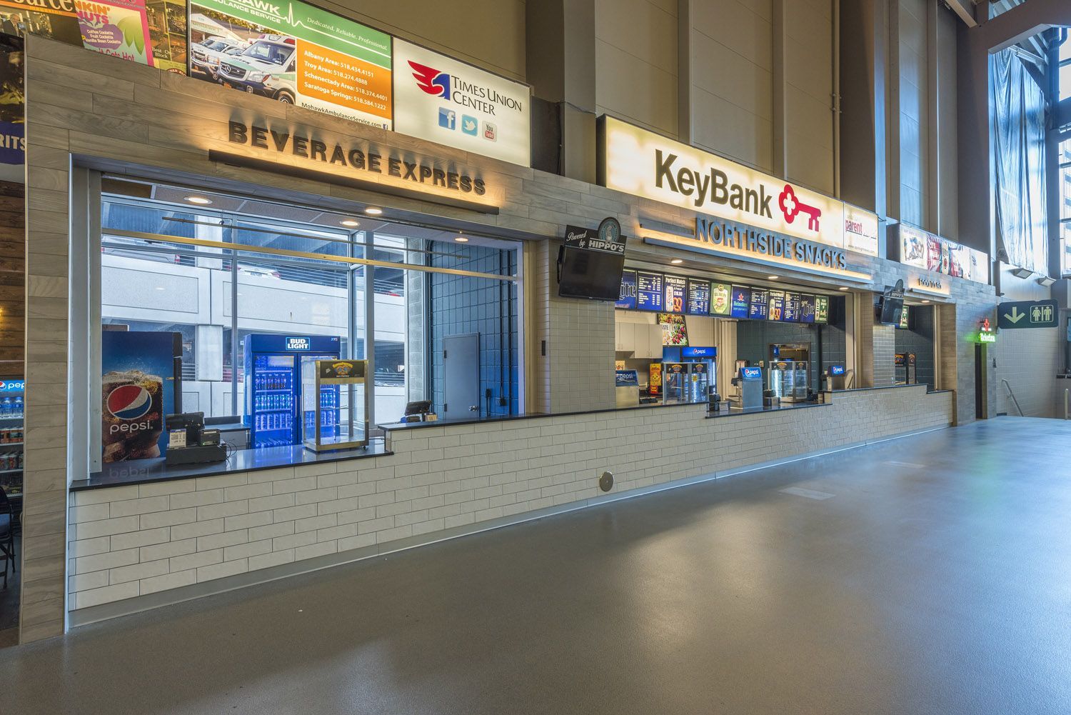 A counter-service area with a Beverage Express station and a KeyBank sign, illuminated under recessed ceiling lighting.