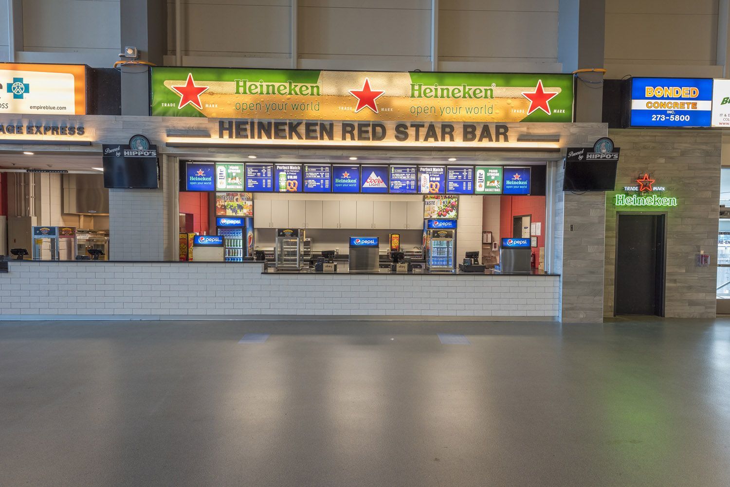 Heineken Red Star Bar concession stand at an indoor arena with a menu board displayed above the service counter.
