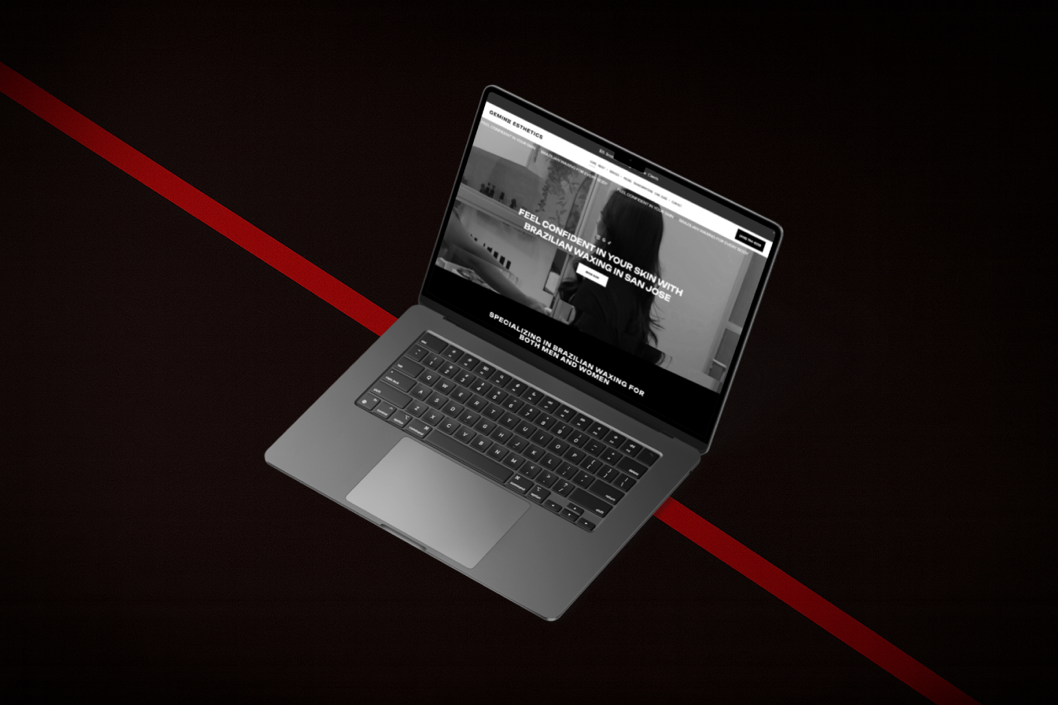 Laptop displaying a website on a dark background.