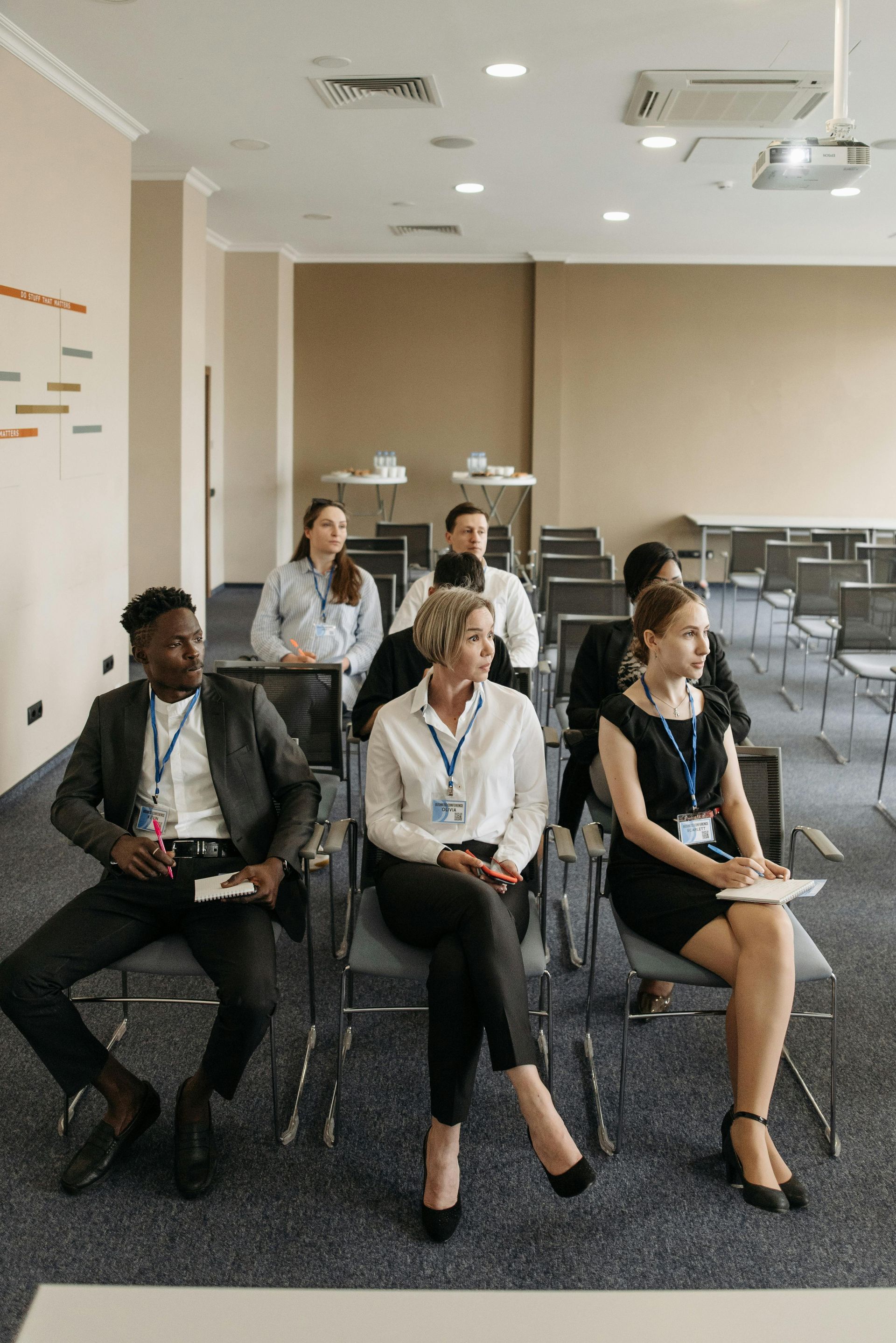 Audience seated in a conference room, listening during a presentation