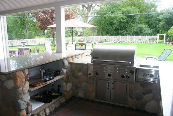 Nice outdoor kitchen with grassy area in front — Clarkston, MI — Lowries Landscape Inc