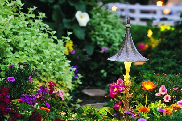 Lamp next to flowers — Clarkston, MI — Lowries Landscape Inc