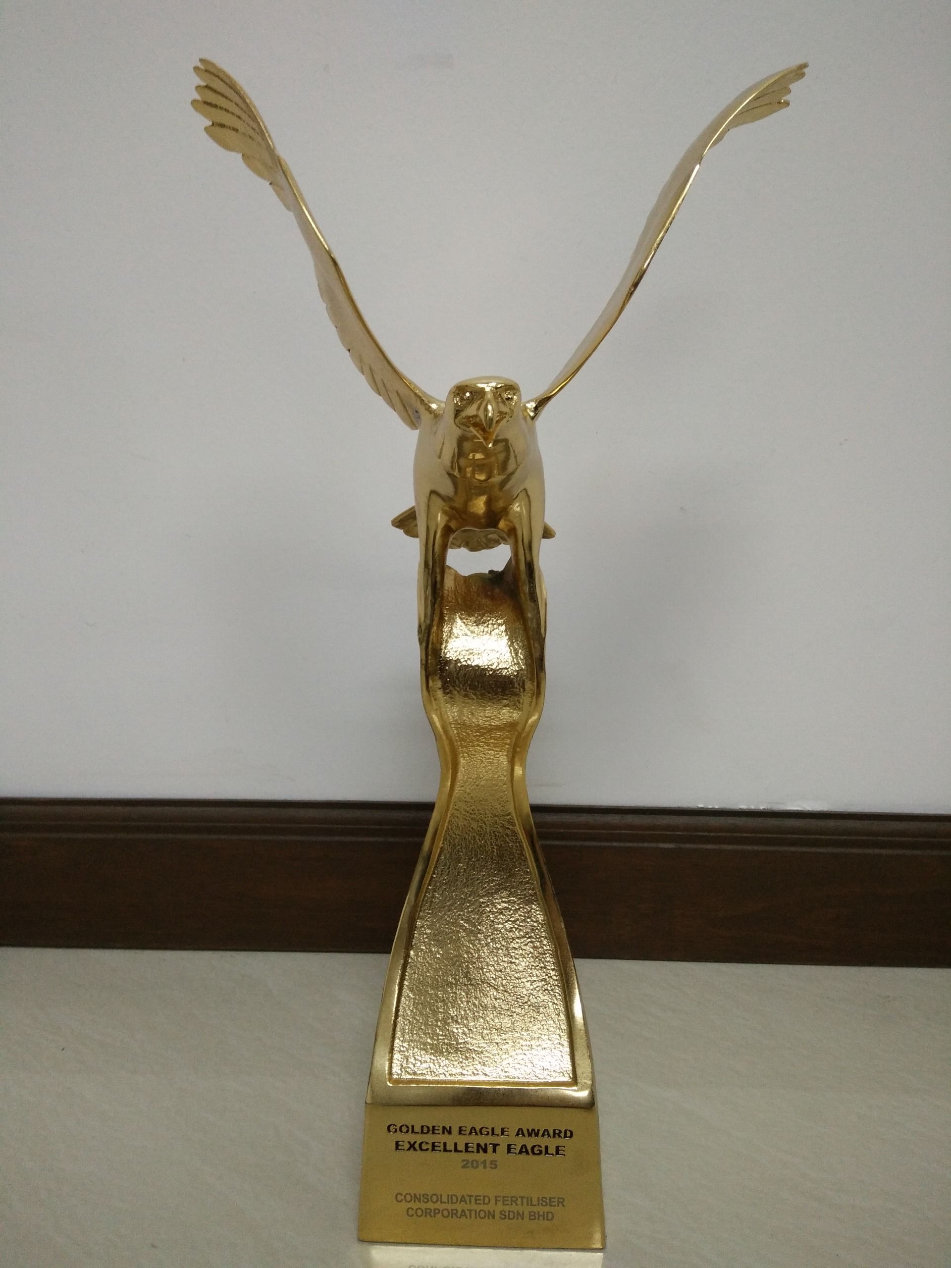 A gold statue of an eagle with its wings outstretched