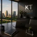 Modern office with city skyline view, laptop on desk, and KT Growth Partners branding on the wall