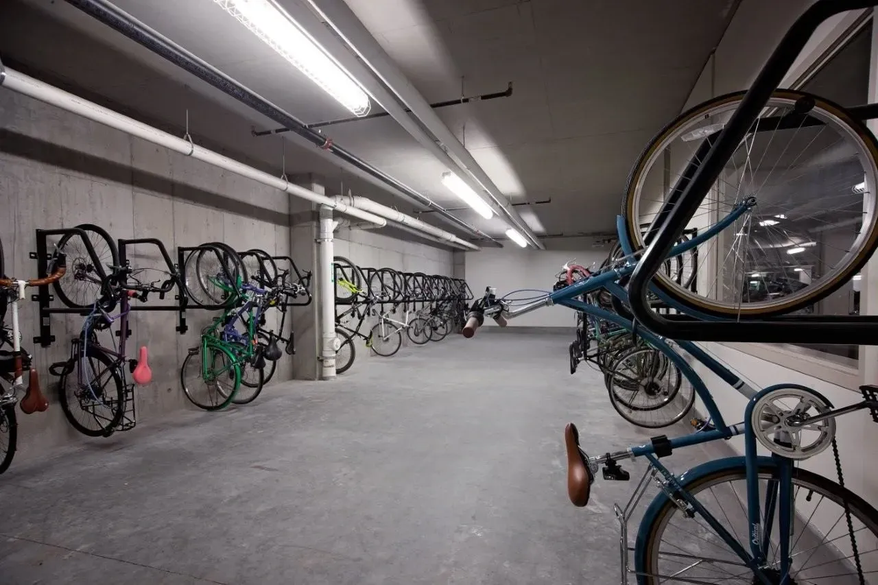 Secure indoor bicycle parking area with wall-mounted racks.