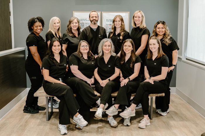 A group of people in scrubs are posing for a picture.