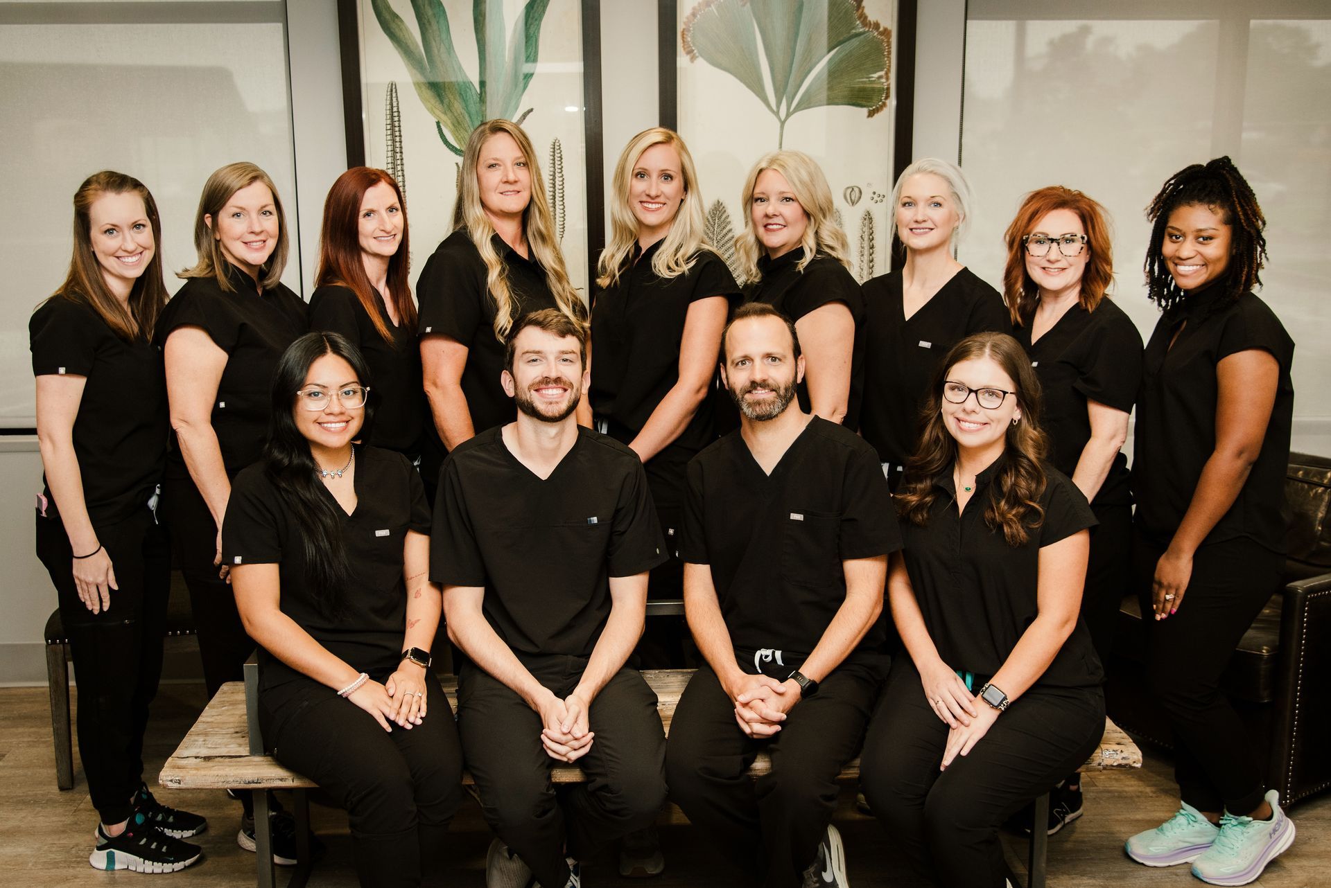A group of people in scrubs are posing for a picture.