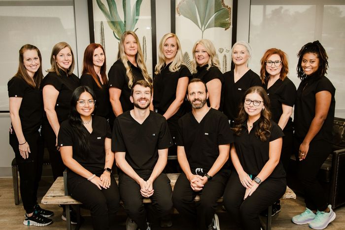 A group of people in scrubs are posing for a picture.
